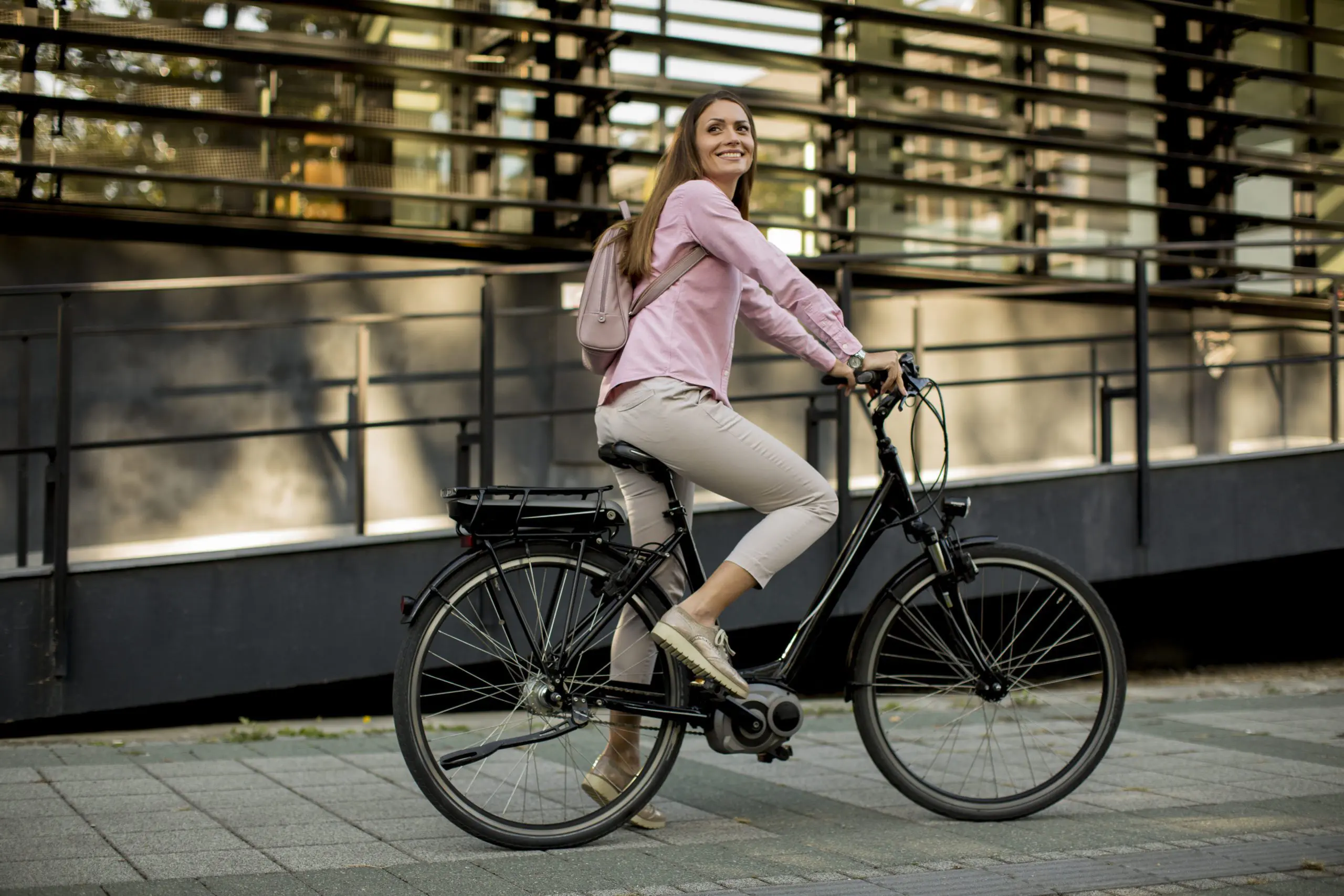 Young woman riding e bike in urban enviroment